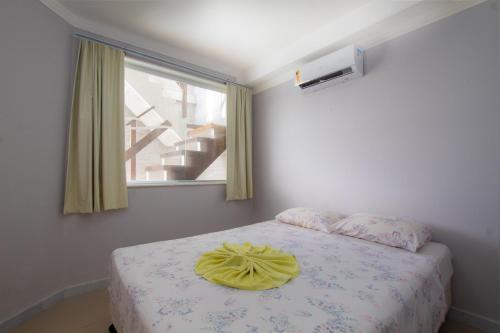 尼西亚弗洛雷斯塔Sua Cobertura no Tabatinga Beach Resort com a Prosper的一间卧室配有一张黄色枕头的床