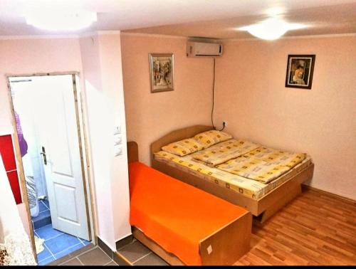 索科矿泉村Studio Isakovic的一间小卧室,配有床和橙色长凳