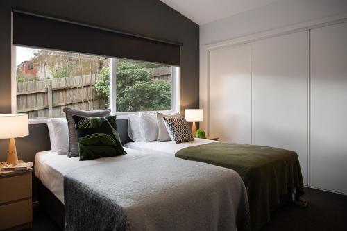 戴尔斯福特德尔福林度假屋的一间卧室设有两张床和大窗户