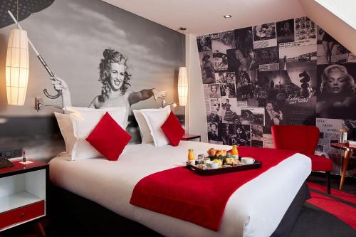 巴黎普拉坦酒店的酒店客房设有一张带红色毯子的大床
