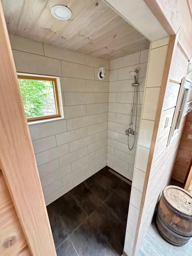 劳拉斯玛Natura Sauna的带淋浴和桶的浴室