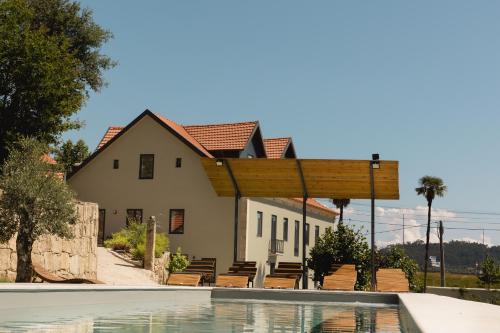塞洛里库迪巴什图Quinta dos Tojais的房屋前有游泳池的房子