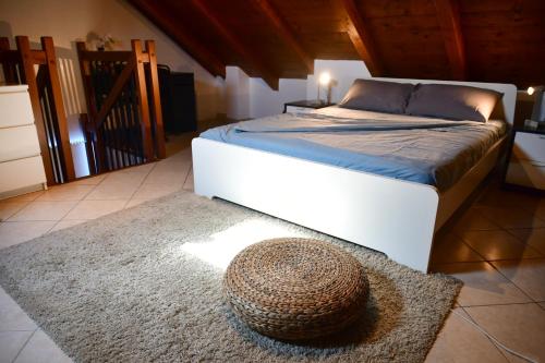 PioltelloNew LOFT free WI-FI & free parking [Milano-Linate]的卧室配有一张床,地毯上挂有草帽