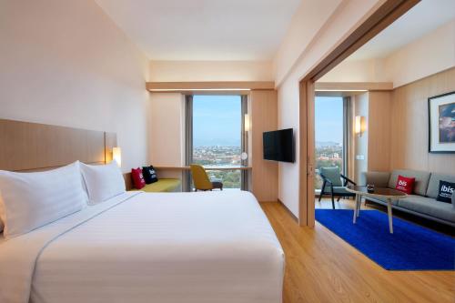 万隆宜必思万隆一室公寓酒店的酒店客房设有一张大床和一张沙发。