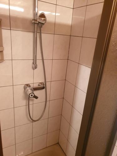 Almzeithütte am Seeberg的浴室内带软管的淋浴