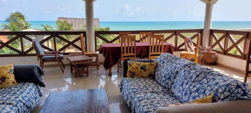 Grand-PopoGuesthouse Bambou Beach的客厅配有沙发和桌子,享有海景。