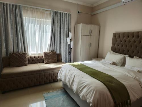 贝拉贝拉Bela Valley Guest House的一间卧室设有一张大床和一个窗户。