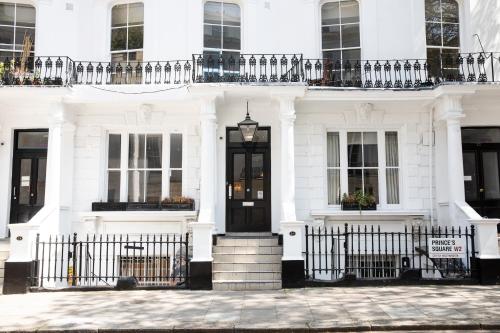伦敦王子广场旅馆的一间白色的房子,设有黑色的门和栅栏