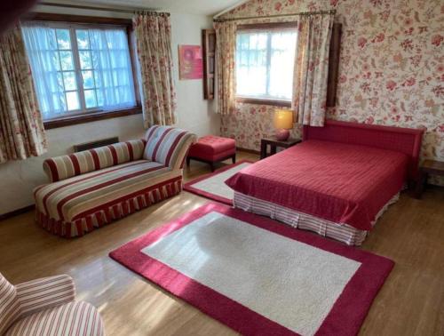 巴塞卢什Casa Mata da Ribeira的一间卧室配有一张床和一张沙发