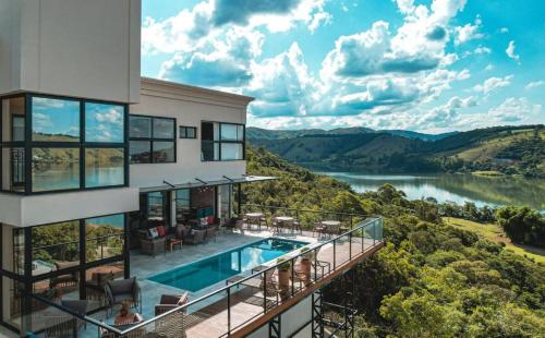 卡皮托利乌Vista do Lago Hotel的河景房屋 - 带游泳池