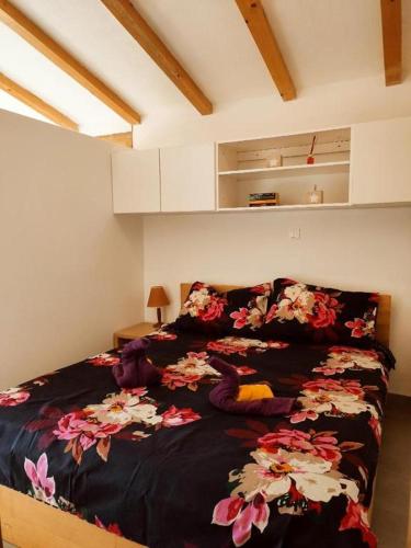 温克兰Valle Verde的一间卧室配有一张带黑色毯子和鲜花的床