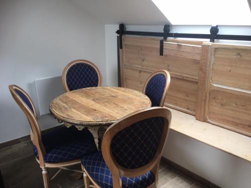 Le Clos De La Perdrix的一张桌子和椅子、一张木桌和一张桌子及椅子。