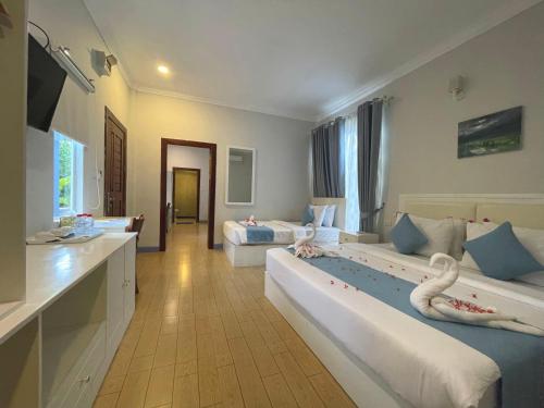 瓜隆岛SCARLET SAILS BUNGALOW的酒店客房带两张床,还有天鹅