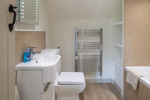 谢伯恩Dorset Holiday Barns的白色的浴室设有卫生间和水槽。