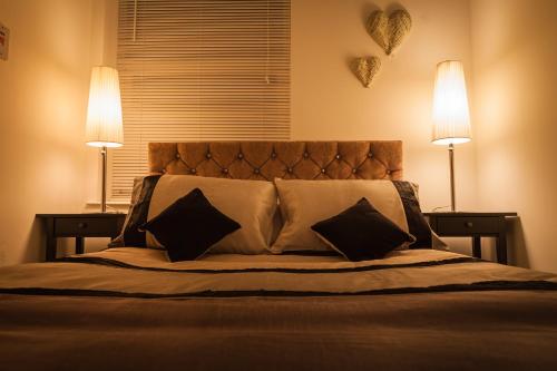 哈利法克斯Urban Chic Suite - Simple2let Serviced Apartments的一间卧室配有一张带两盏灯的床。