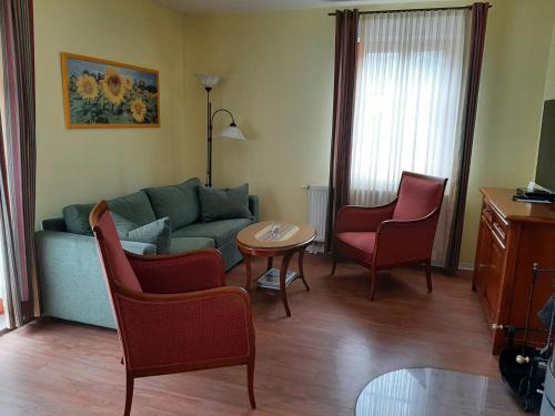 格拉尔-米里茨Residenz Lausitz - Apartments für Urlaub mit Hund的客厅配有沙发、椅子和桌子