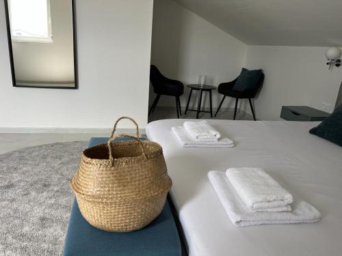 扎顿Vitas Apartments的一间卧室配有一张带两条毛巾和一篮子的床