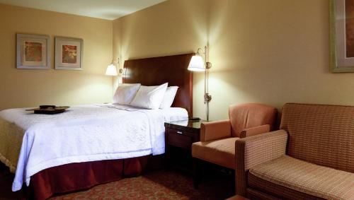 彭德尔顿彭德尔顿汉普顿酒店的配有一张床和一把椅子的酒店客房