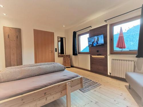 菲根贝格Ferienwohnung-1-Gilfert的一间卧室配有一张床和一台电视。
