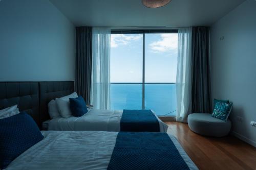 蓬他达维托亚Sea View Villa Mar Lindo nr Ponta do Sol的一间卧室设有一张床和一个大窗户
