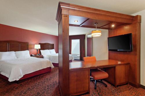 西塔科西雅图机场/28号大道汉普顿酒店及套房的酒店客房配有一张床和一张带电脑的书桌