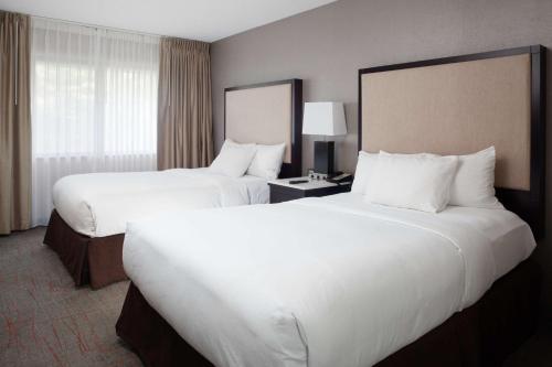 迈阿密斯堡代顿/迈阿密斯堡逸林套房酒店的配有白色枕头的酒店客房内的两张床