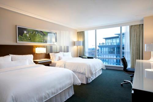 里士满The Westin Wall Centre, Vancouver Airport的酒店客房设有两张床和大窗户。