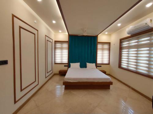 坎努尔Nandhanam Holidays的一间卧室配有床和蓝色窗帘