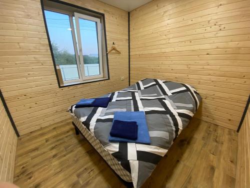卡缅涅茨-波多利斯基Ехо Природи的木制客房内的一张大床,设有窗户