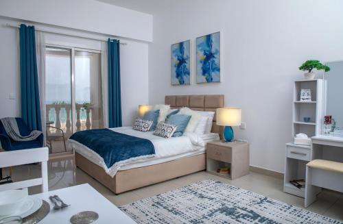 拉斯阿尔卡麦Amazing sea view studio的一间卧室配有一张蓝色调的大床