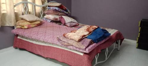 伯豪BB Bahau Homestay的一张带毯子和枕头的小床