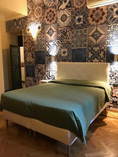 佛罗伦萨吉里欧酒店的卧室配有一张床和瓷砖墙