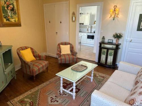 迪纳尔Charmant T2 saint Enogat的客厅配有沙发、椅子和桌子