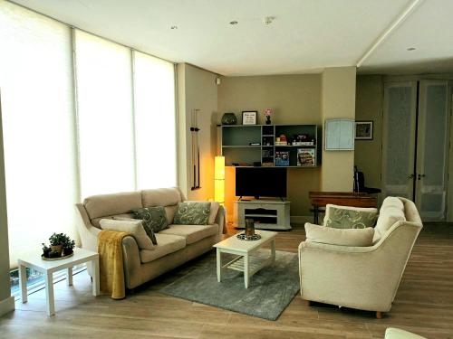 沃特福德Beautiful 2-Bed Apartment near Waterford City的客厅配有两张沙发和一台电视机