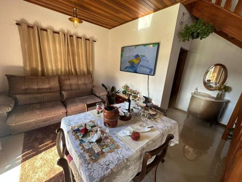 坎波斯杜若尔当Raio de Sol na Montanha的客厅配有桌子和沙发