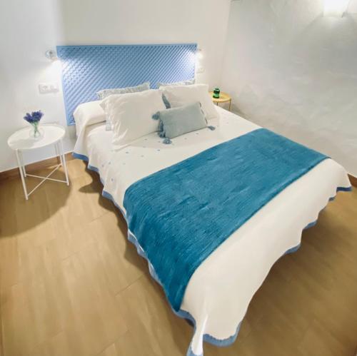 亚伊萨Casa Gercko 2的一间卧室配有一张大床和蓝色床头板