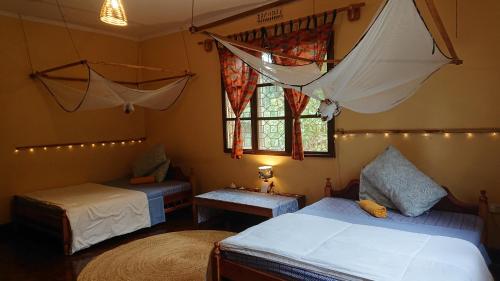莫希Kiwavi Home的一间卧室设有两张床和窗户。