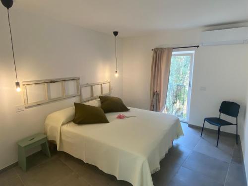马尔切西内Relais PINF的卧室设有一张白色大床和一扇窗户。