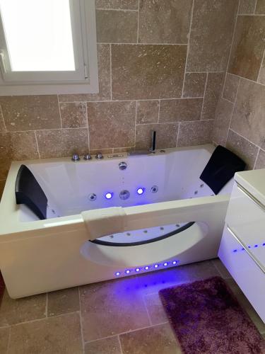 罗什福尔Loft atlantique Rochefort的浴室内设有带紫色灯的浴缸