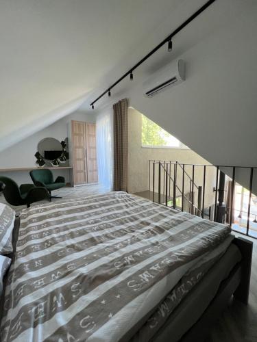 巴拉顿凯奈谢Beige Villa Balatonkenese的一间带大床的卧室和一个阳台