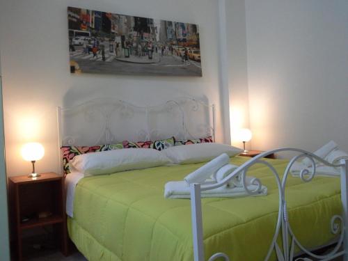 伊塞尔尼亚阿尔巴住宿加早餐旅馆的一间卧室配有一张带绿床单的床和两盏灯。