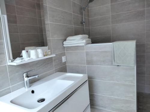 阿旺桥Résidence 14 Moulins的浴室配有白色水槽和淋浴。