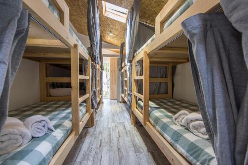 卡帕里卡海岸Vila Maria Mix Dorm by HOST-POINT的铺有木地板的客房内配有两张双层床。