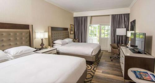 圣奥古斯丁希尔顿圣奥古斯丁历史海湾酒店的酒店客房设有两张床和电视。