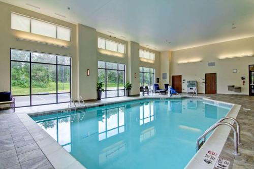 克利夫顿帕克克利夫顿公园希尔顿惠庭套房酒店的一座大型游泳池,位于一座带窗户的建筑内