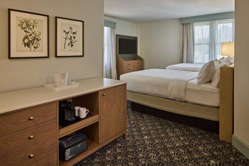奥古斯塔奥古斯塔鹧鸪宾馆 - 希尔顿Curio Collection酒店的酒店客房配有一张床、一张书桌和一台电视。