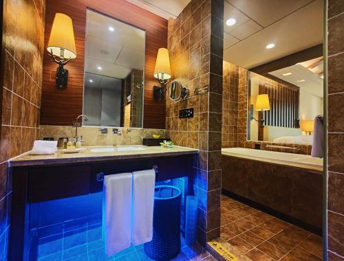 上饶三清山希尔顿度假酒店的一间带水槽、浴缸和镜子的浴室