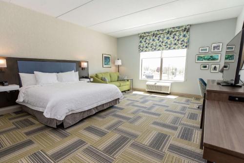 北锡拉丘兹雪城华美达酒店的配有一张床和一张书桌的酒店客房