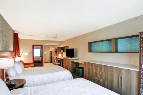 代顿Home2 Suites By Hilton Dayton Vandalia的酒店客房设有两张床和电视。