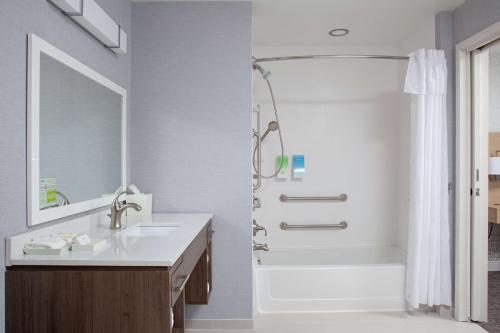 布卢明顿Home2 Suites by Hilton Bloomington的白色的浴室设有水槽和淋浴。